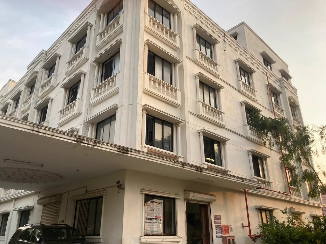 Four-storey apartment block exterior painted in soft neutral tones