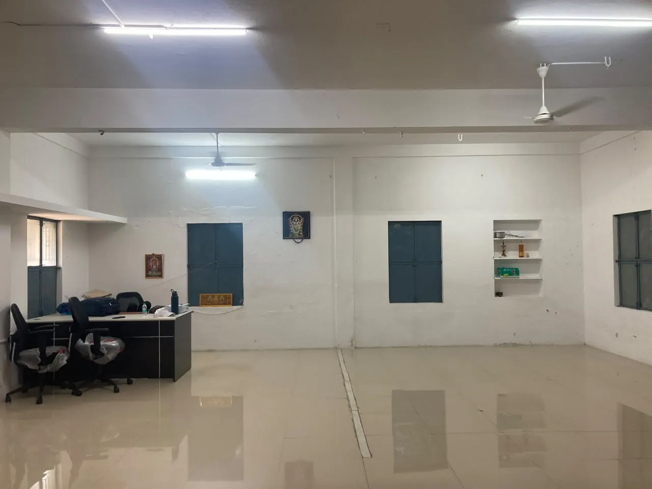 Commercial interior hall with white walls and a polished floor